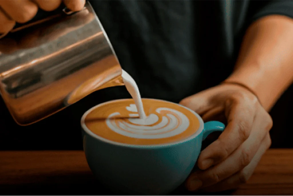 Specialty coffee in Medellín: a barista at Café Hotel preparing the best breakfast buffet in El Poblado.